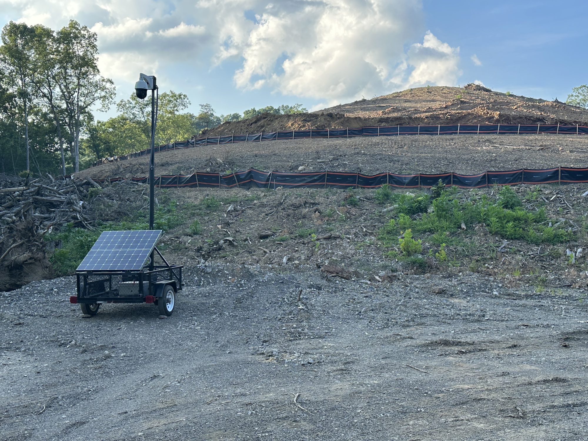 Solar-powered surveillance trailer with a mast-mounted PTZ camera deployed on a West Virginia job site